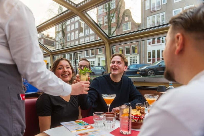Amsterdam: Evening Cocktail Cruise along the canals - Boarding at Damrak: Getting on Fast and Choosing Your Side