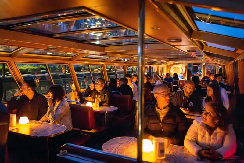 Amsterdam: Evening Cruise with Optional Wine and Snacks - The canal route: from 17th-century warehouses to Skinny Bridge