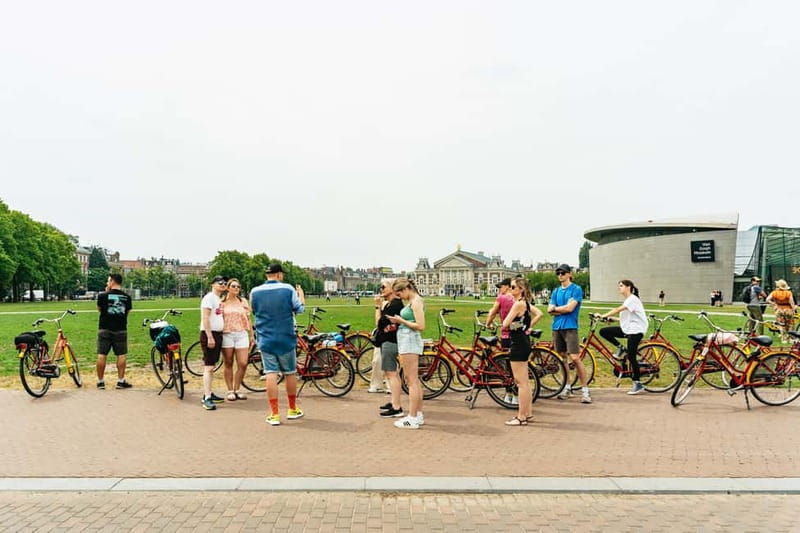 Amsterdam: Guided Bike Tour City Centre in EN/DE/FR/ES - AmsterBike Start: Helmets, Headphones, and Getting Comfortable Fast