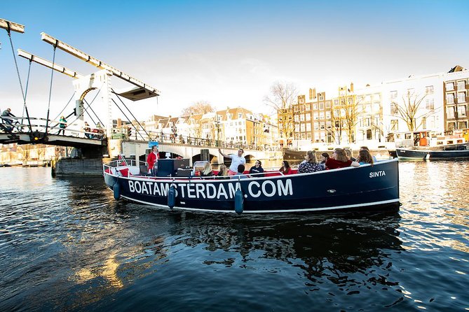 Amsterdam Open Boat Cruise with Live Guide and Two Drinks - Potential drawbacks: covered boats, foggy windows, and loud distractions