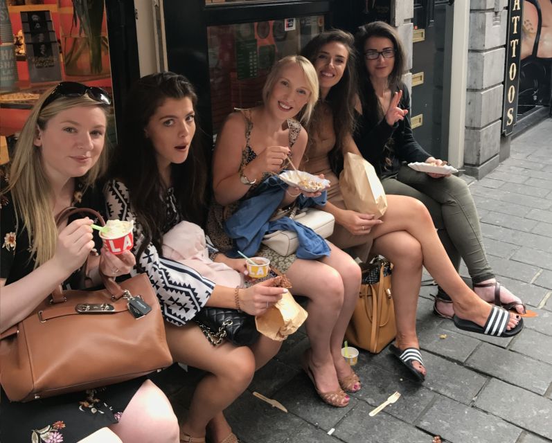 Amsterdam: Red Light District and Local Pub Tour - Entering the Red Light District core: narrow streets and peep shows