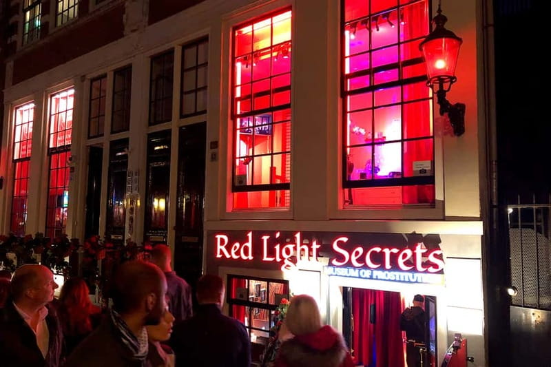 Amsterdam: Red Light District Tour - Dam Square: Big City Energy Meets Small Street Realities