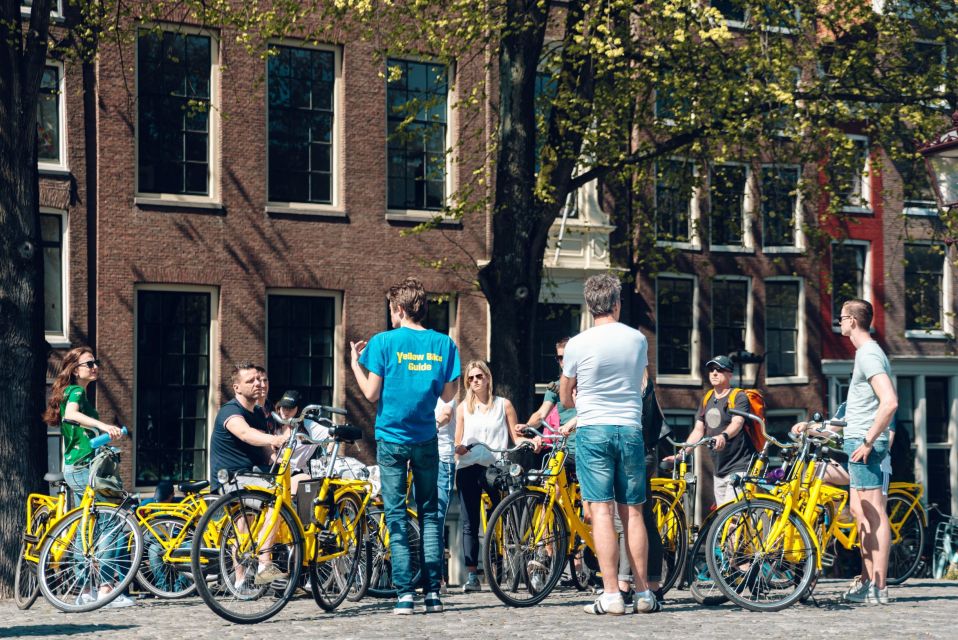 Amsterdam: Relaxed City Highlights Guided Bike Tour - Getting started at Nieuwezijds Kolk: Mokum by bike