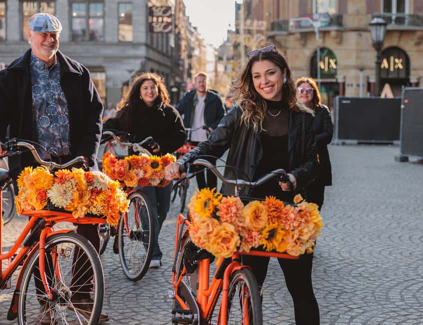 Amsterdam: Top Highlights Guided Bike Tour EN/DE/ES/FR/IT/CN - What you actually get: guide stories, short photo time, and included treats